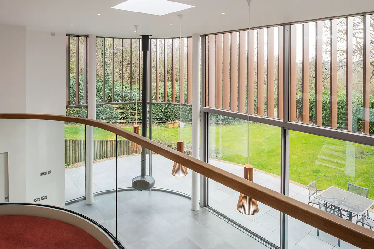 Double-Height Glass Extension Interior view of double-height glass extension with garden outlook and pendant lights